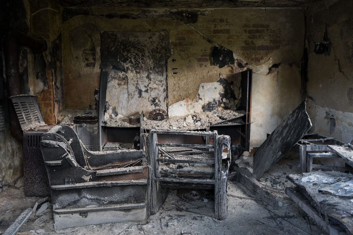 A fire- and smoke-affected interior with belongings, the kind of contents content cleaning and restoration recovers